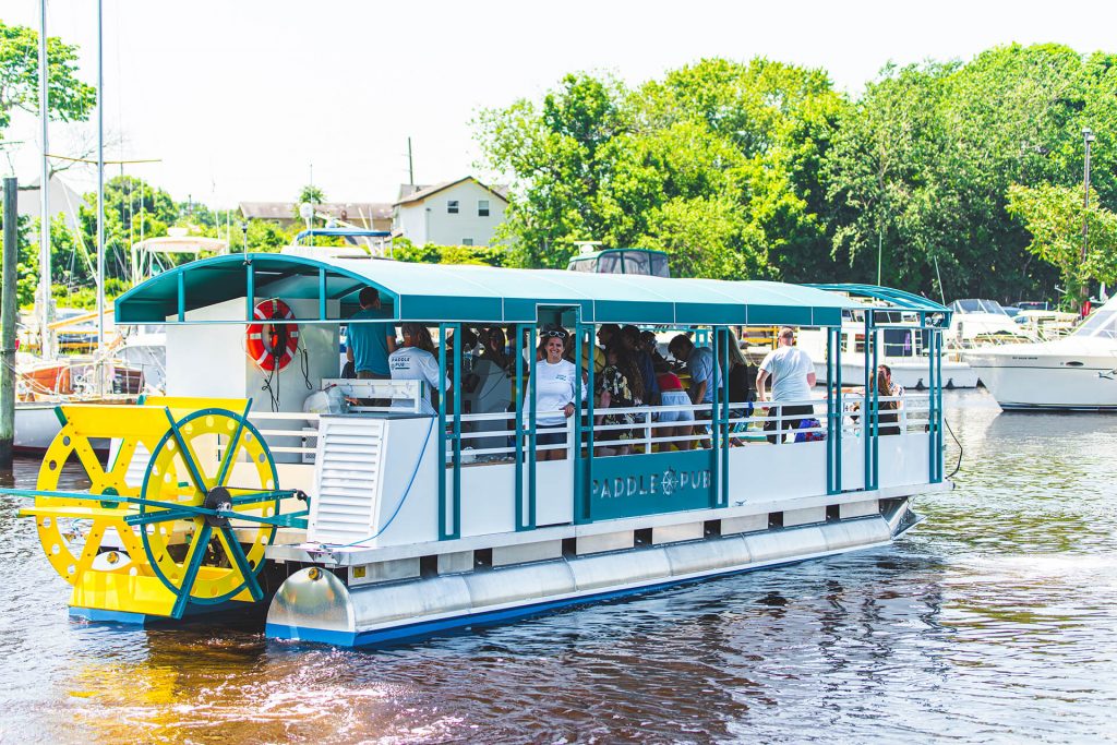 Group of people in paddle pub cycle boat