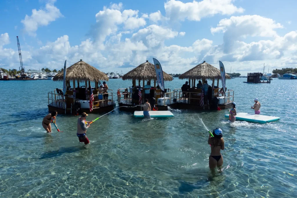 Aerial view of a tiki boat operating along a scenic waterfront, showcasing experiential tourism