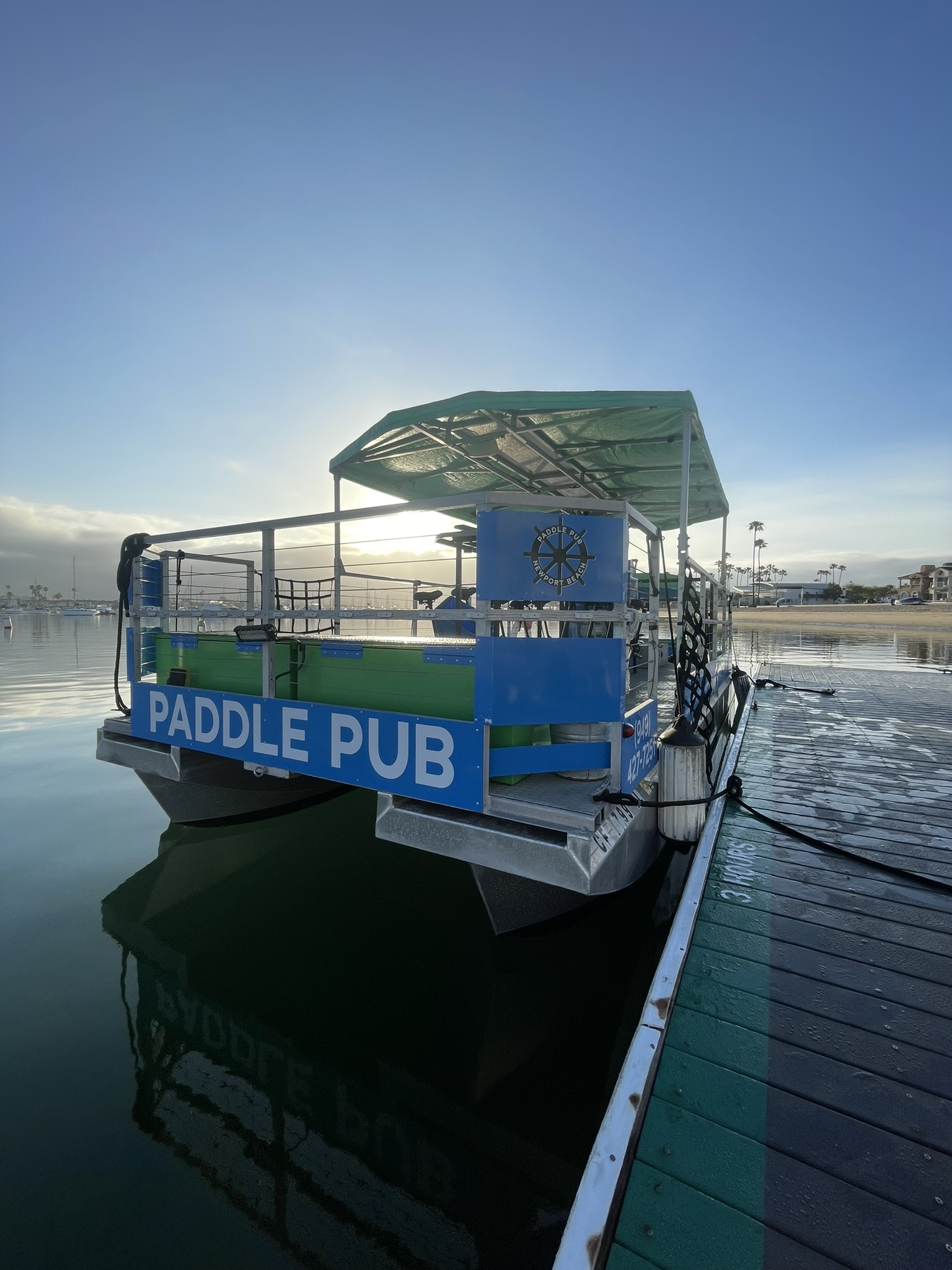 Paddle Pub vessel docked at sunset